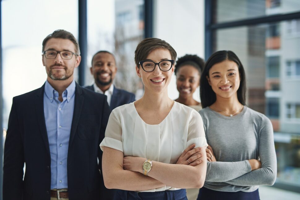 Smiling business team standing in office