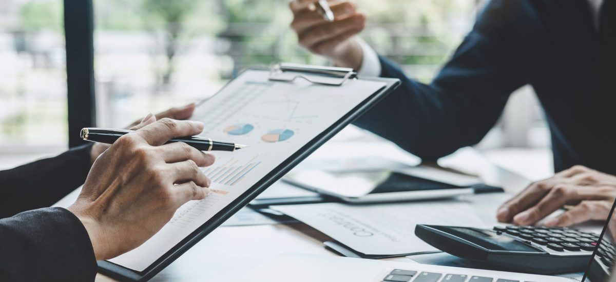 A man checking financial results with holding a pen