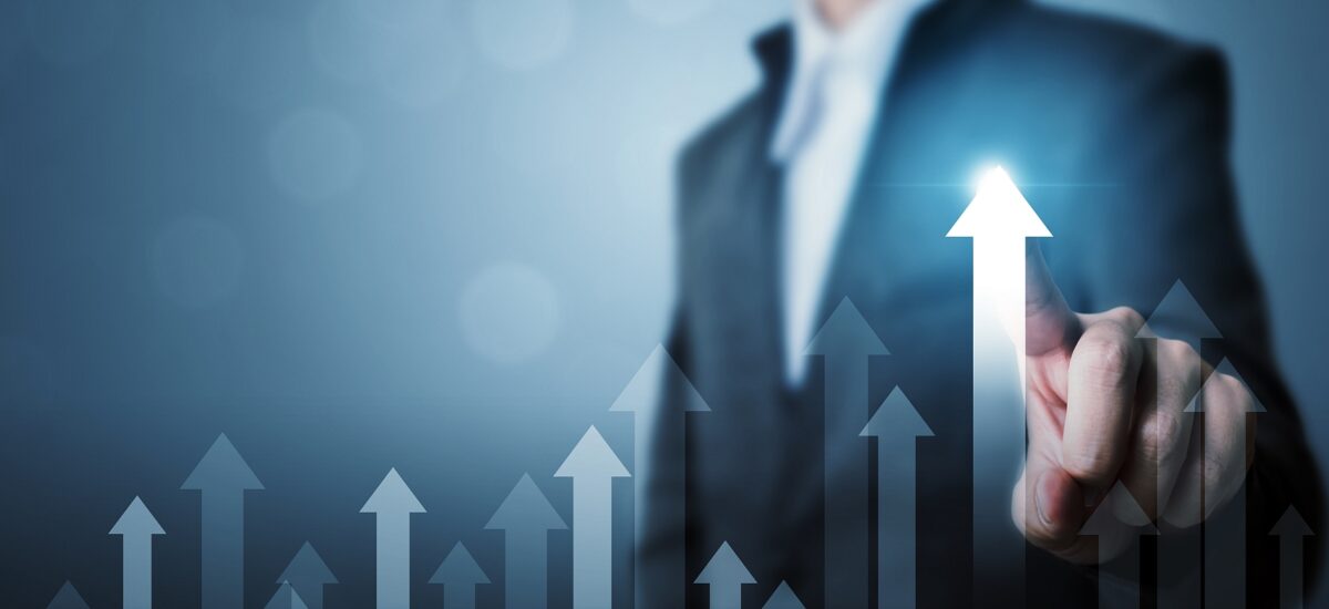 Businessperson pointing at rising arrows indicating upgrade