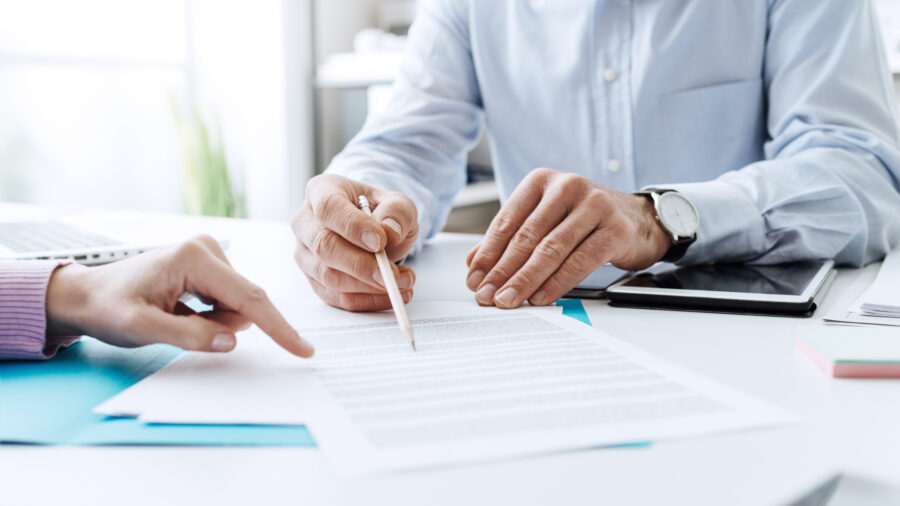 Close-up of hands checking banking document