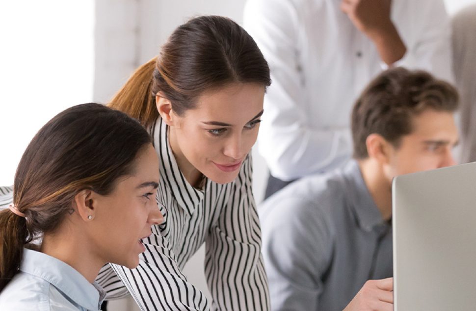 Group of professionals collaborating at a desk, representing diversity and inclusion