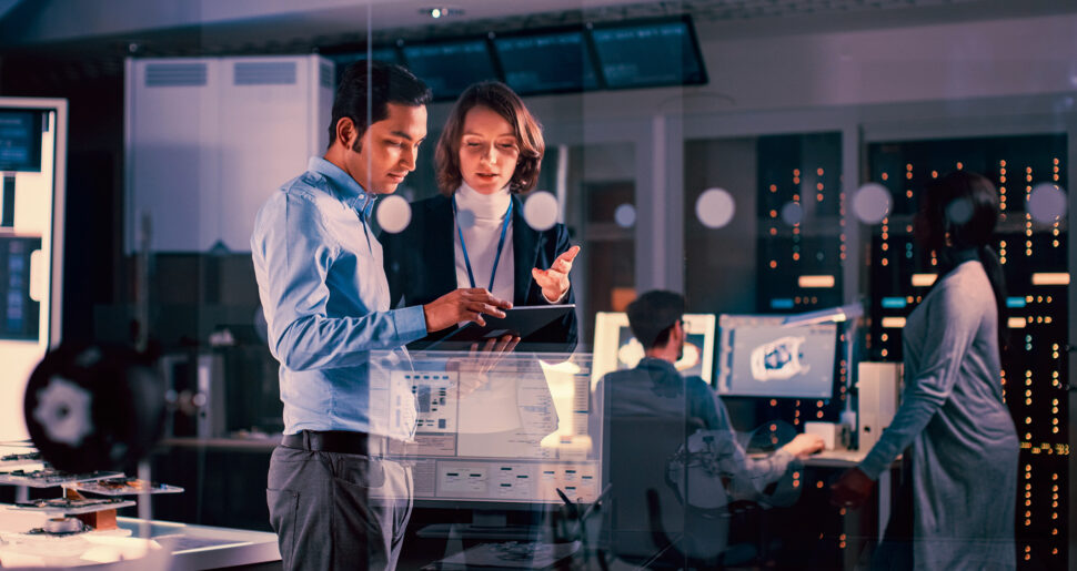 Team members discussing in a modern IT operations room