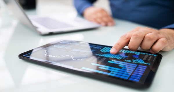 Finger tapping on a digital stock chart on tablet